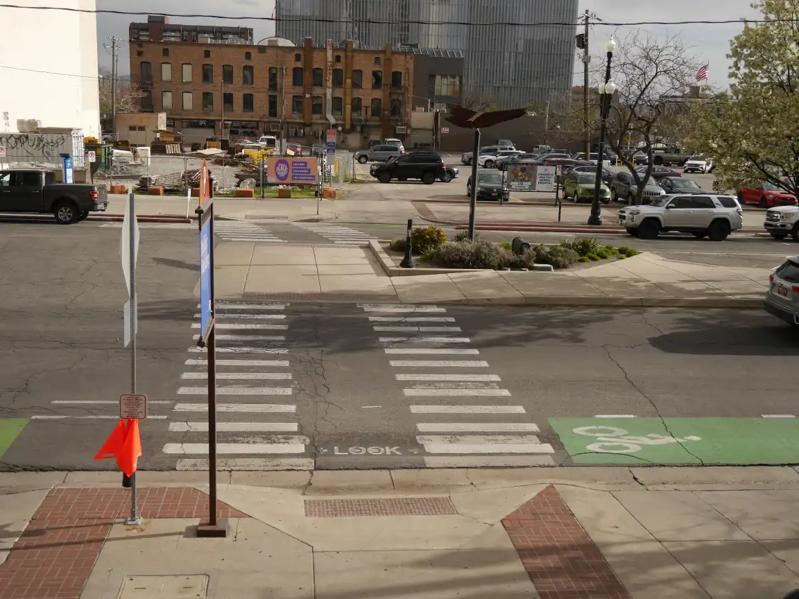 A midblock crosswalk on 300 S viewed from American Plaza