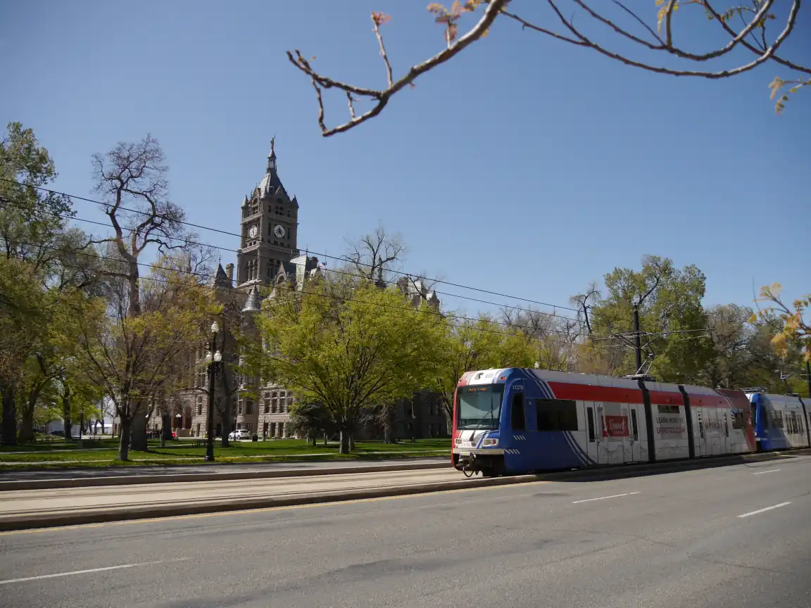 A Red Line train in front of Washington Square Park and the Salt Lake City and County Building
