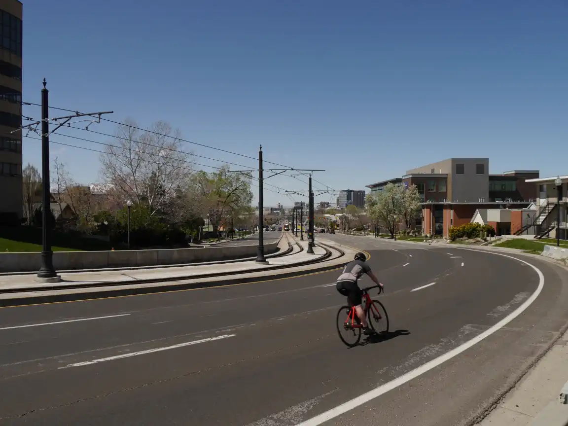 A cyclist going down the curve on University Blvd.