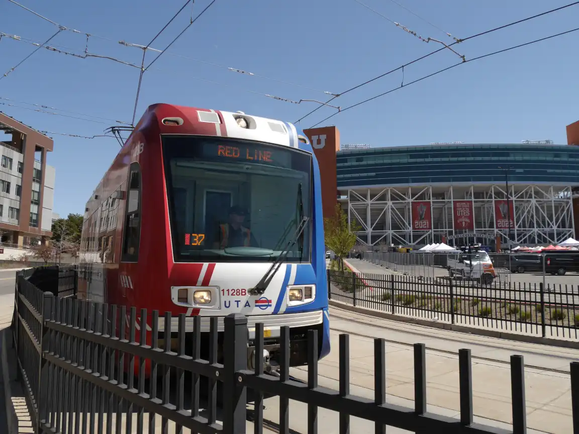 A Red Line train turning into Stadium Station, with the stadium in the background