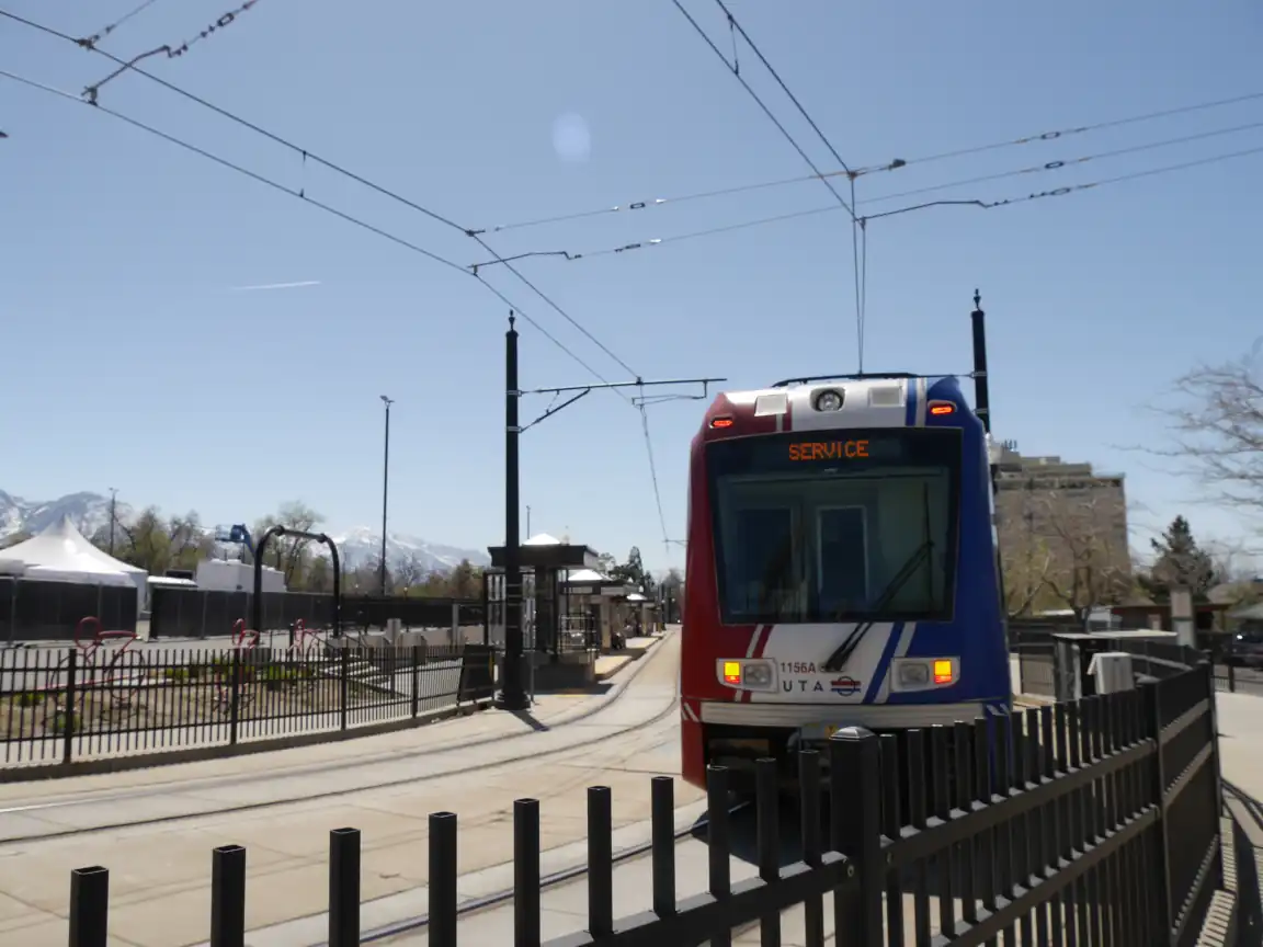 A Red Line train entering Stadium Station, the screen reading 'SERVICE'
